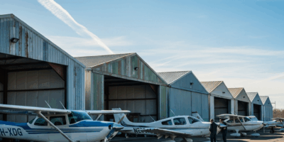row of t hangars at a small general aviation airport single 20260331 094220